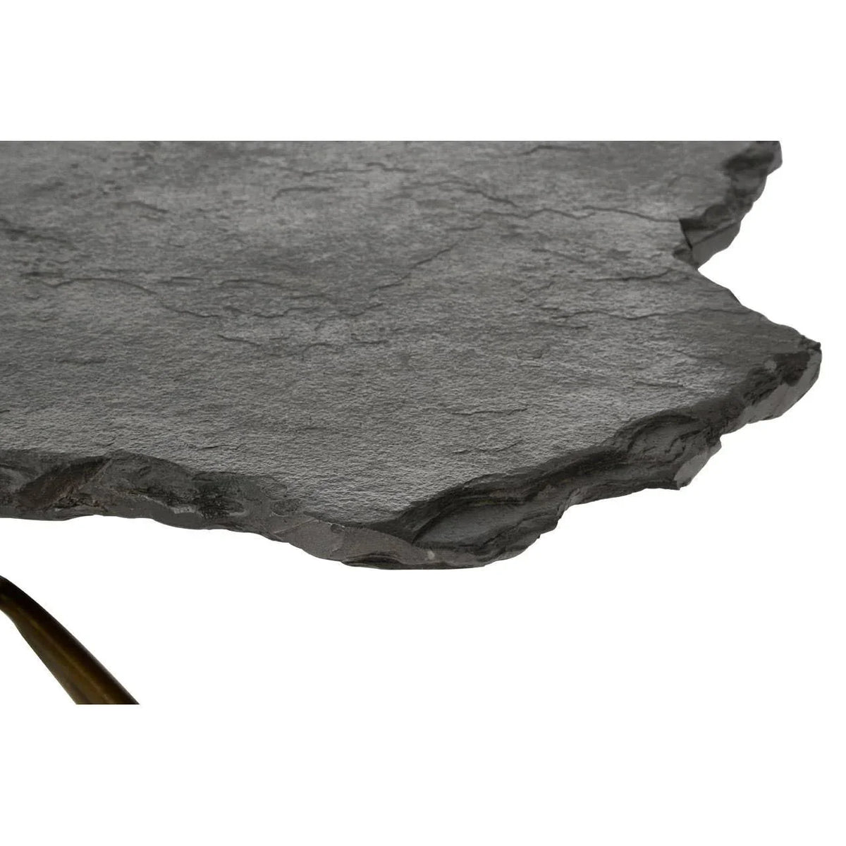 Closeup of black stone coffee table top with natural rough edges