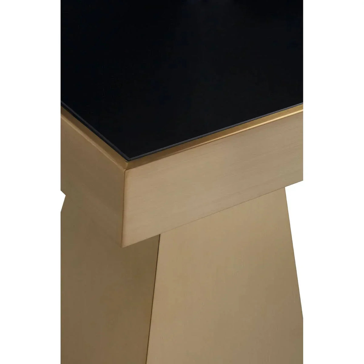 Close up of gold pedestal table base with black glass tabletop