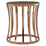 Round metal accent table with bronze finish and glass top