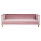 A three-seat sofa upholstered in soft pink fabric, featuring a minimalist design with clean lines and no visible armrests. The sofa is supported by sleek, golden metal legs, adding a modern touch to its overall aesthetic