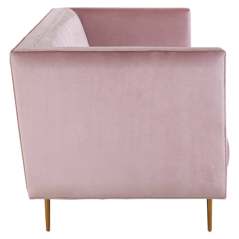The Otylia 3 Seat Pink Sofa features a soft pink velvet upholstery with a sleek, modern design. It has a low back and armrests, complemented by slender gold legs that elevate the piece. The overall aesthetic is chic and contemporary, suitable for various interior styles