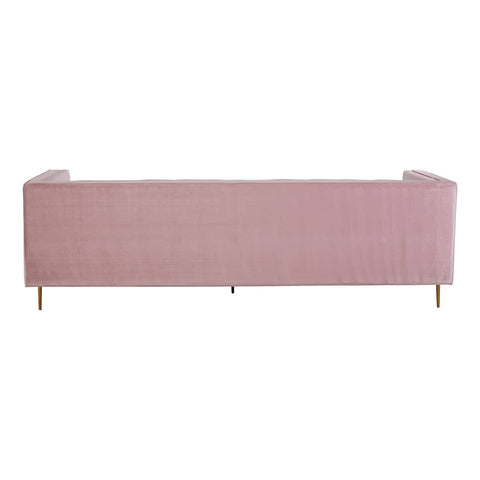 A three-seat sofa upholstered in a soft pink fabric, featuring a minimalist design with clean lines and a low back. The sofa is supported by slender wooden legs, adding a touch of elegance to its overall appearance
