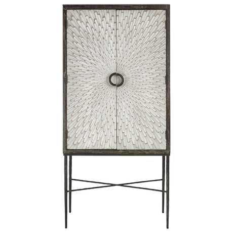 Milan Two Door Elm Wood Wine Cabinet featuring a textured front with a circular handle, supported by slender metal legs in a crossed design. The cabinet has a natural wood finish, showcasing the grain of the elm wood