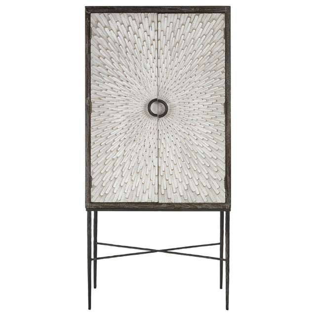 Milan Two Door Elm Wood Wine Cabinet featuring a textured front with a circular handle, supported by slender metal legs in a crossed design. The cabinet has a natural wood finish, showcasing the grain of the elm wood