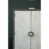 Milan Two Door Elm Wood Wine Cabinet featuring a textured front with a circular handle, set against a dark green wall. The cabinet showcases a natural wood finish with intricate patterns, emphasizing its elegant design