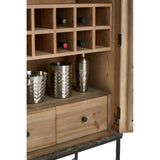 The interior of the Milan Two Door Elm Wood Wine Cabinet features a wooden structure with multiple compartments for wine bottles, a pair of silver-colored cocktail shakers, and two drawers at the bottom for additional storage. The cabinet has a natural wood finish, showcasing the grain of the elm wood
