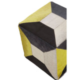 Geometric pouffe featuring a combination of yellow, black, and cream leather panels arranged in a modern design, showcasing a textured surface and a cube shape