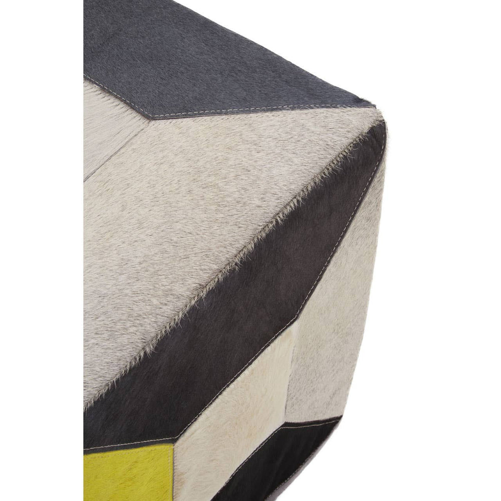 Geometric design pouffe featuring a combination of hair-on leather in shades of black, cream, and yellow, showcasing a textured surface with angular patterns