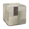 Square pouffe featuring a patchwork design in various shades of grey, with textured fabric and decorative stitching details