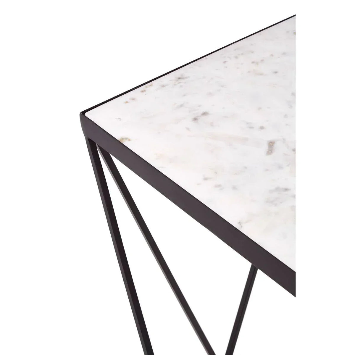 Corner view of marble top table with black metal frame and modern geometric legs