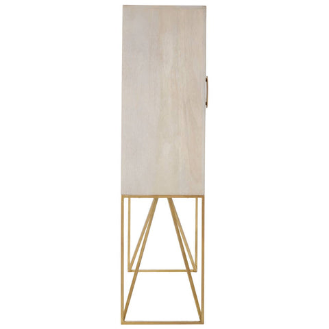 Tall cabinet made of white wash mango wood with a smooth surface and a single door, featuring a minimalist design. The cabinet stands on a sleek, gold metal frame with angled legs, creating a modern aesthetic suitable for home decor