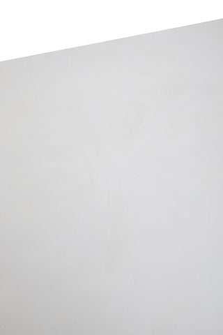 A close-up view of the surface of a white wash mango wood dining table, showcasing a smooth, light-colored finish with subtle wood grain patterns. The edges are slightly rounded, enhancing the table's modern aesthetic