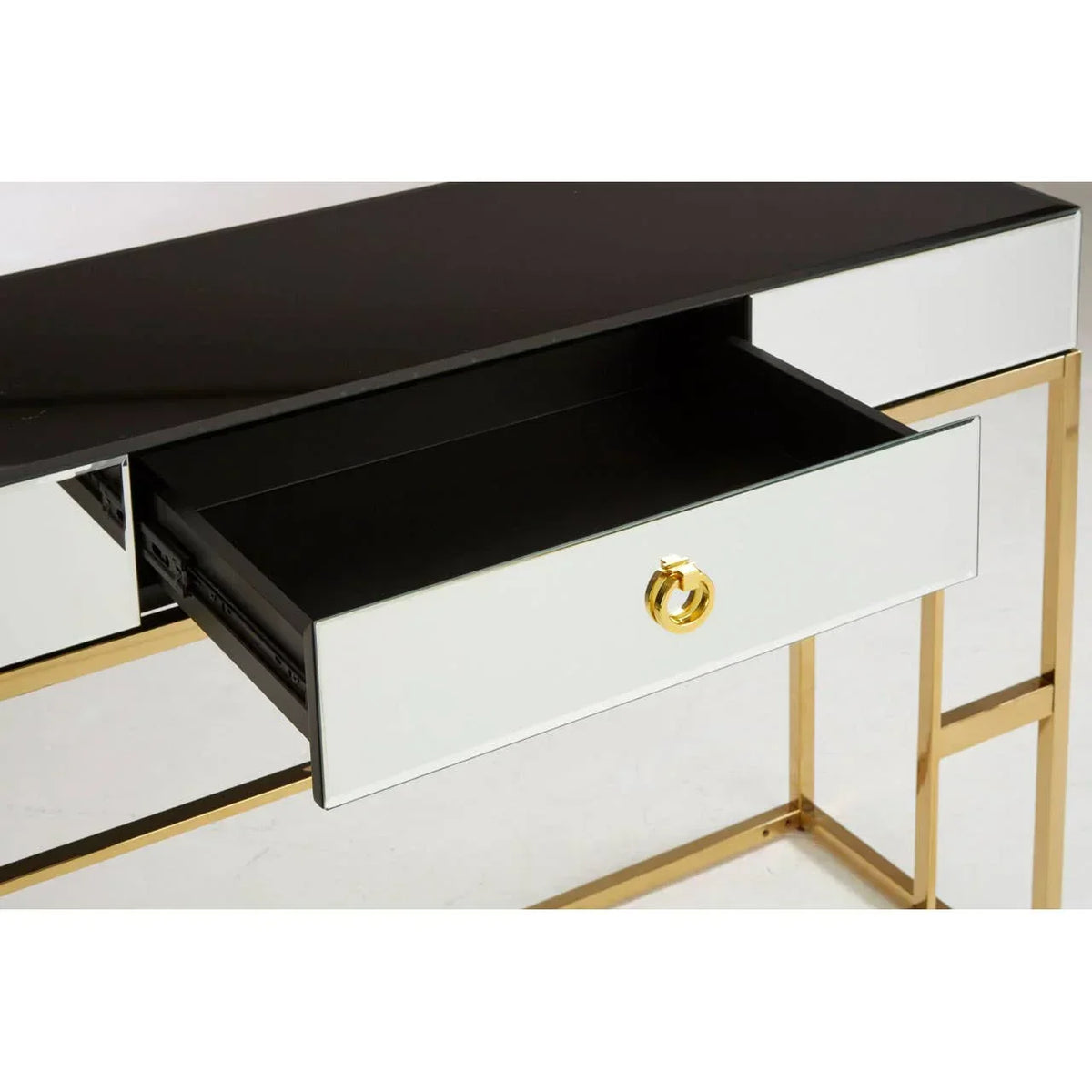 Mirrored console table with gold metal frame and single open drawer