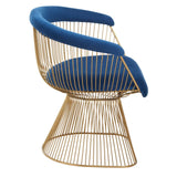 Gold wire accent chair with blue velvet seat and curved backrest, side view