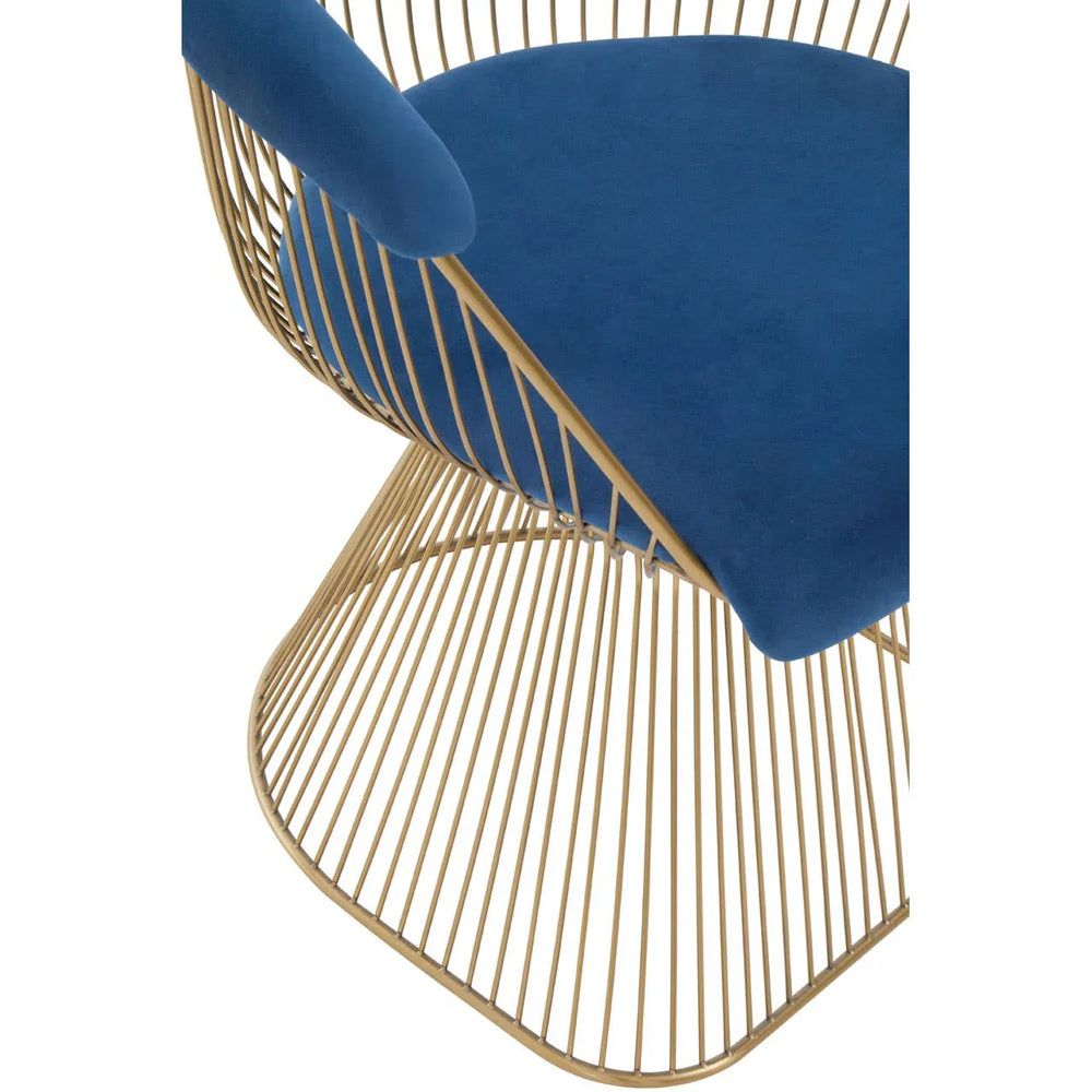 Blue velvet dining chair with gold metal wire frame, close-up of seat and base