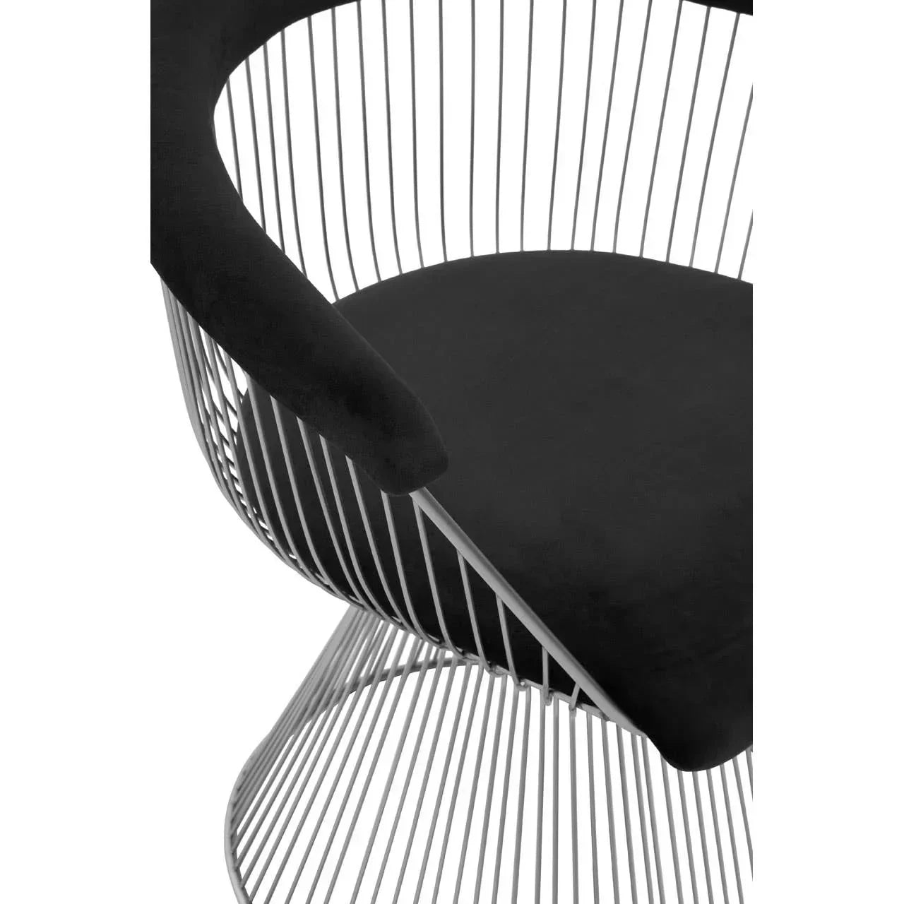 Modern accent chair with black velvet seat and chrome wire frame, close-up angle
