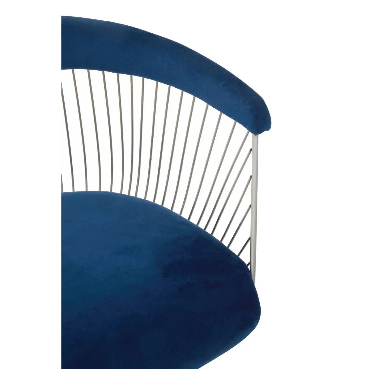 Blue velvet dining chair with curved metal backrest detail