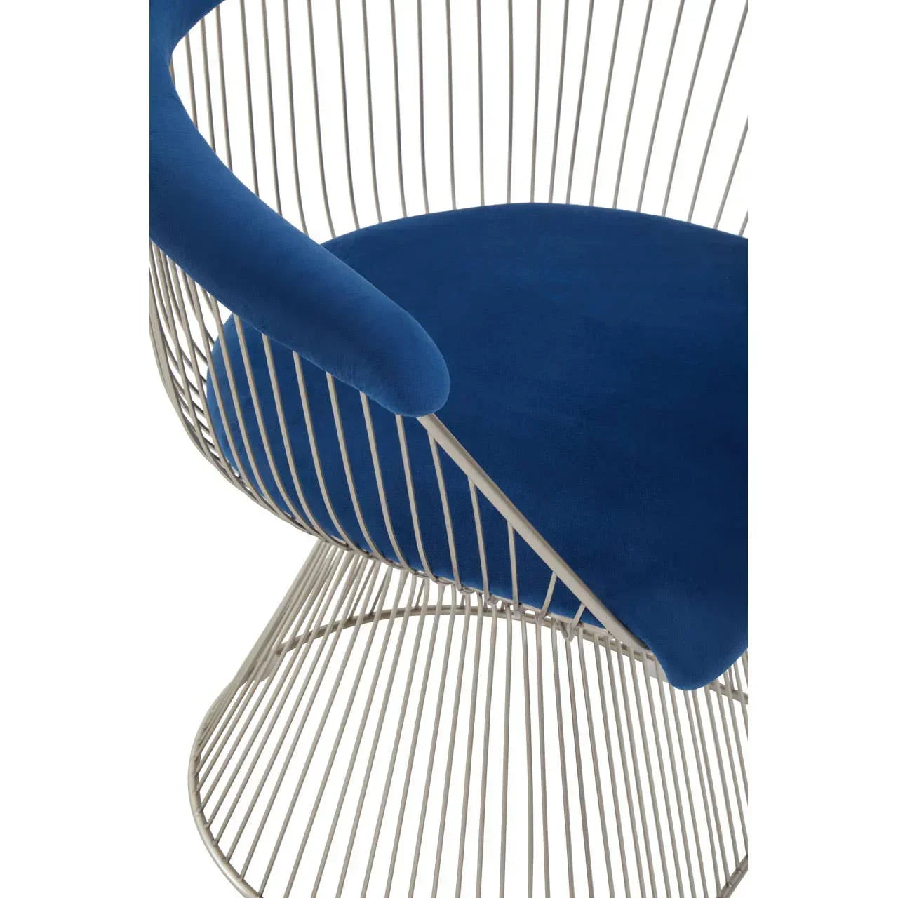 Modern accent chair with silver metal frame and blue velvet seat cushion, close-up view