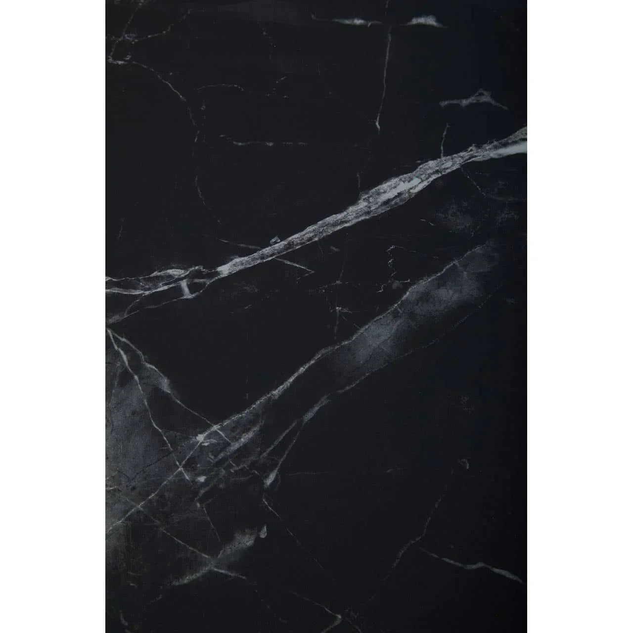 Black marble tabletop with white veining, close view of stone surface pattern