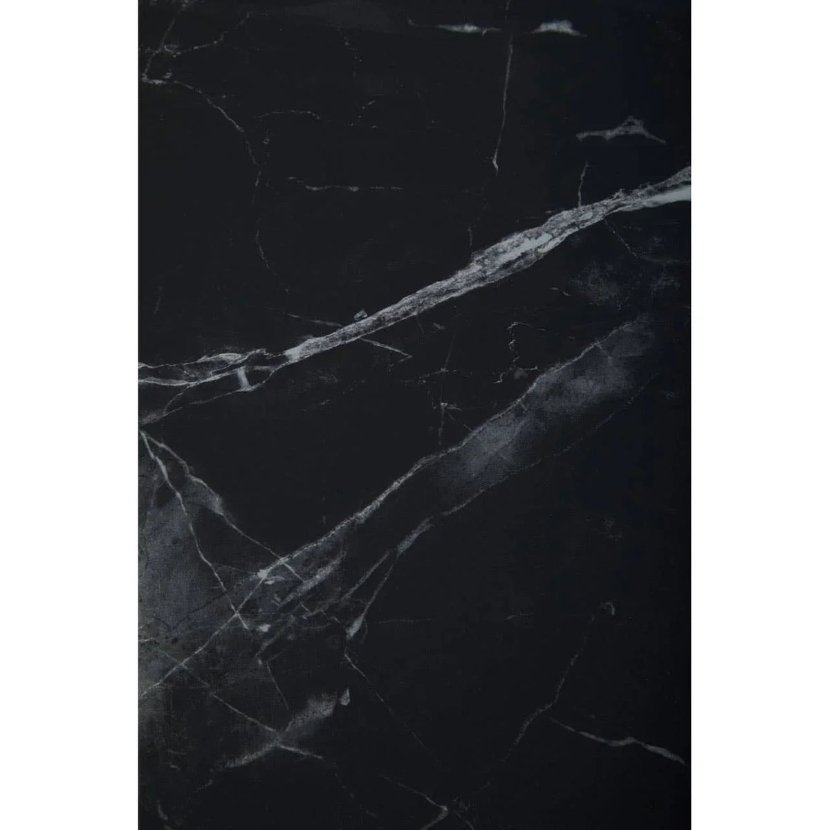 Black marble tabletop with white veining, close view of stone surface pattern