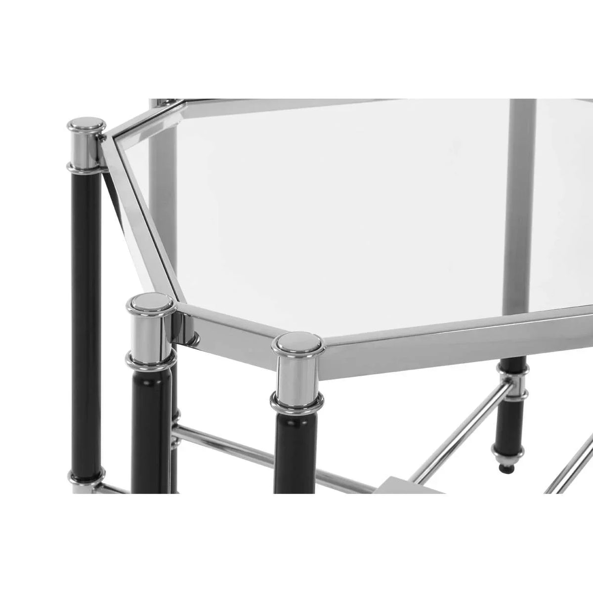 Glass top side table with chrome frame and black legs, close-up of corner detail