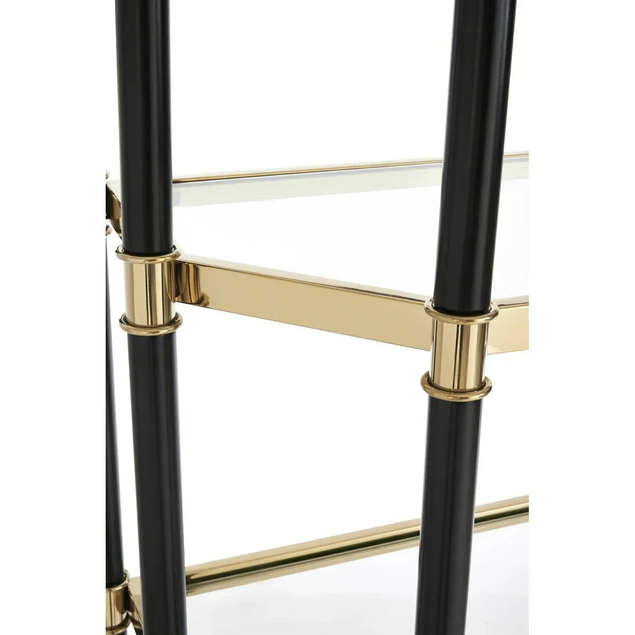 Gold and black metal shelving unit corner with glass shelf close up