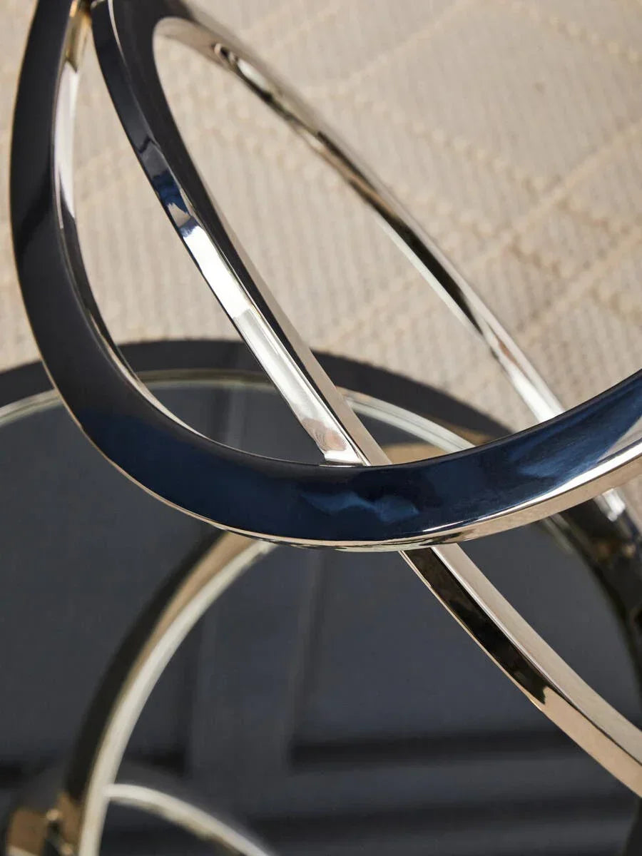Chrome metal coffee table base with intersecting circular frame and mirrored top