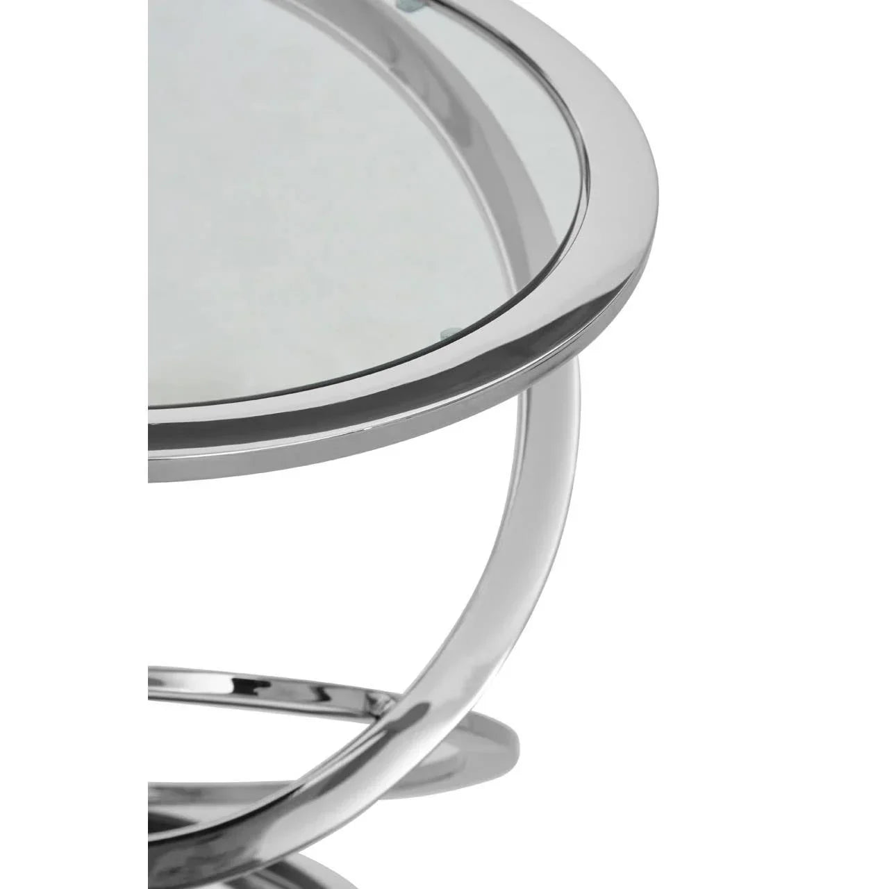 Chrome and glass coffee table with circular metal frame, close-up of tabletop edge