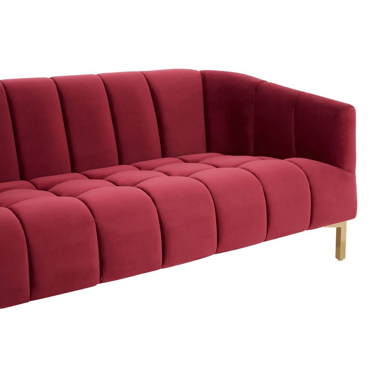 A plush, three-seat sofa upholstered in rich wine-colored velvet, featuring vertical channel tufting on the backrest and seat cushions. The sofa has sleek, angled armrests and stands on elegant, tapered wooden legs