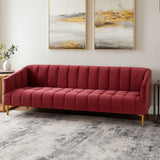 A three-seat sofa upholstered in rich wine-colored velvet, featuring a tufted design and sleek wooden legs. The sofa is positioned in a modern living space with abstract artwork on the wall and a light-colored rug underneath