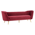Three-seat sofa upholstered in rich wine-colored velvet, featuring vertical channel tufting on the backrest and sleek, tapered gold legs. The design showcases a modern, elegant silhouette with curved armrests