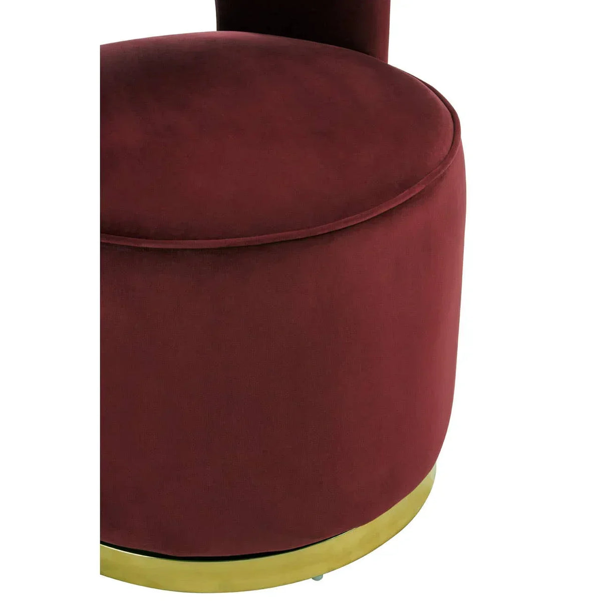 Burgundy velvet accent chair seat with gold base detail, close-up view