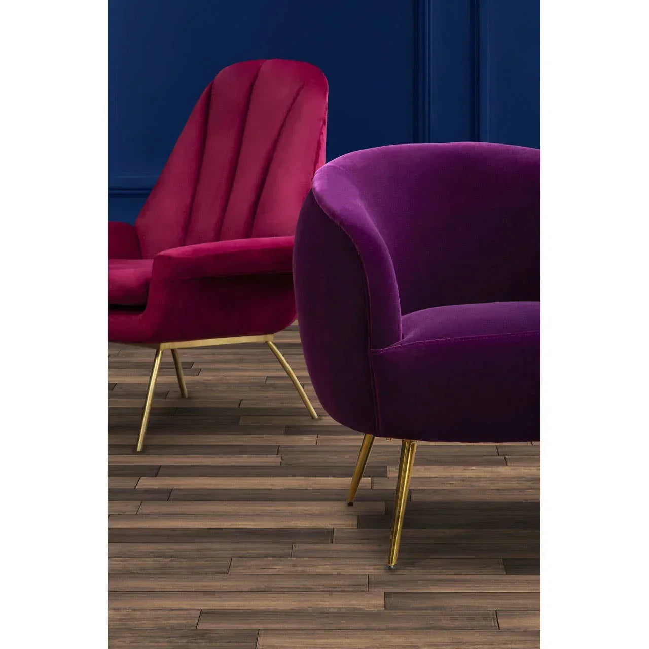 Plum velvet armchair and red accent chair with gold legs on wood floor