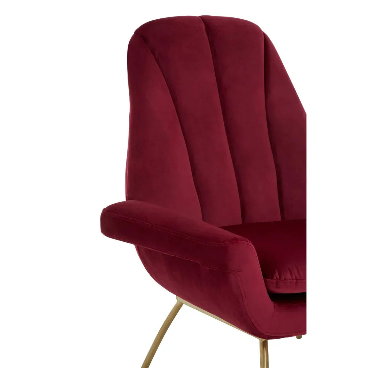 Close-up of red velvet accent chair with gold metal legs and curved backrest