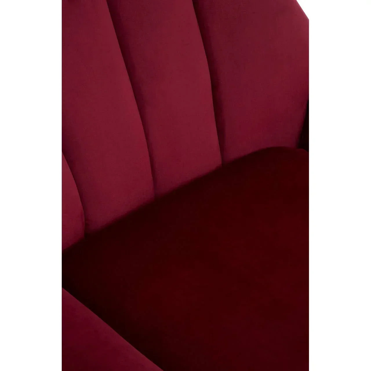 Close up of plush red velvet sofa seat with vertical panel backrest detail
