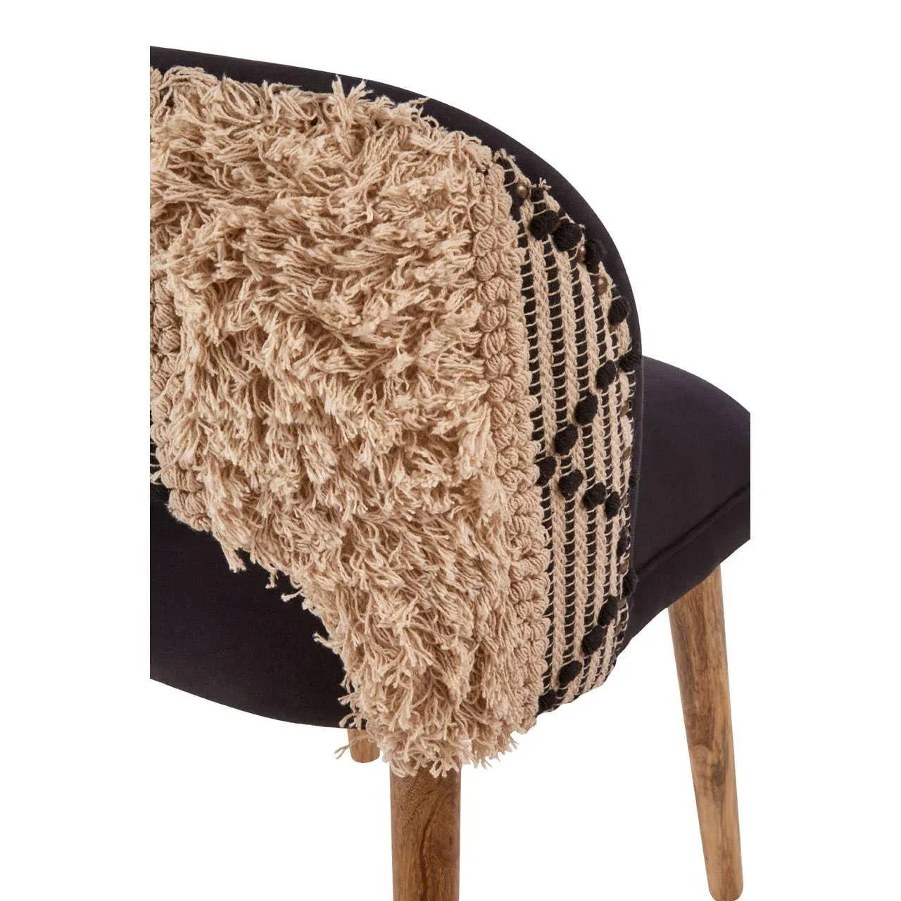 Textured macrame accent on black upholstered chair with wooden legs