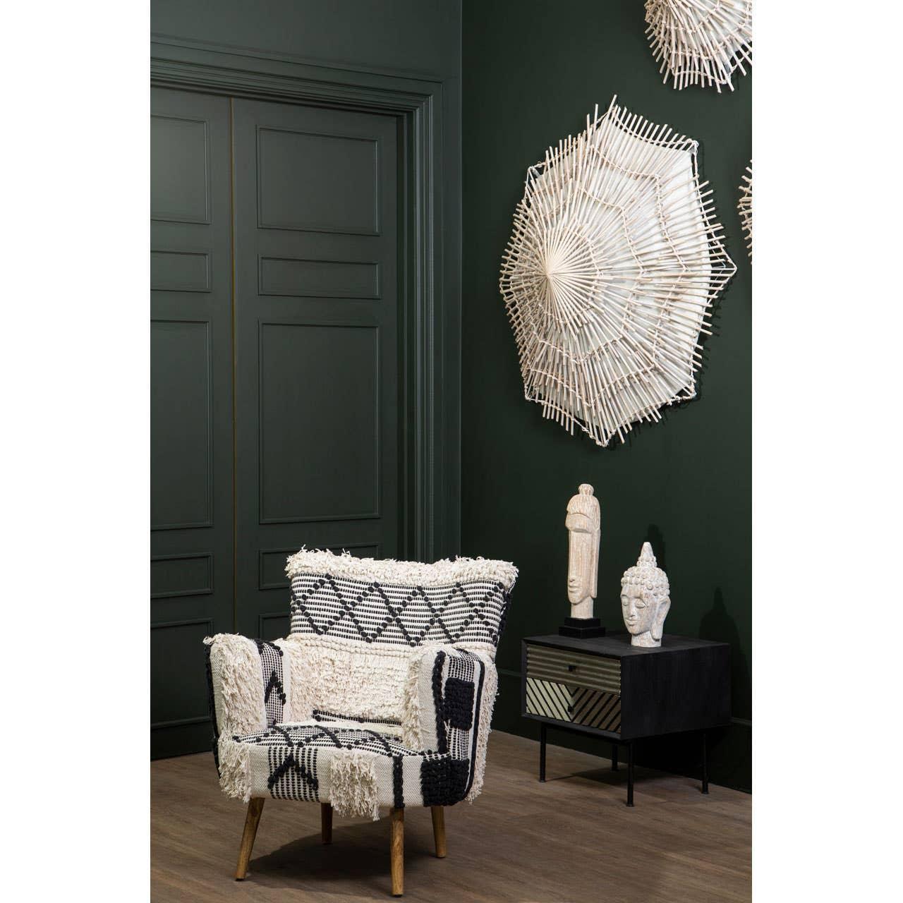 Patterned armchair with black and cream textured upholstery beside black wood side table