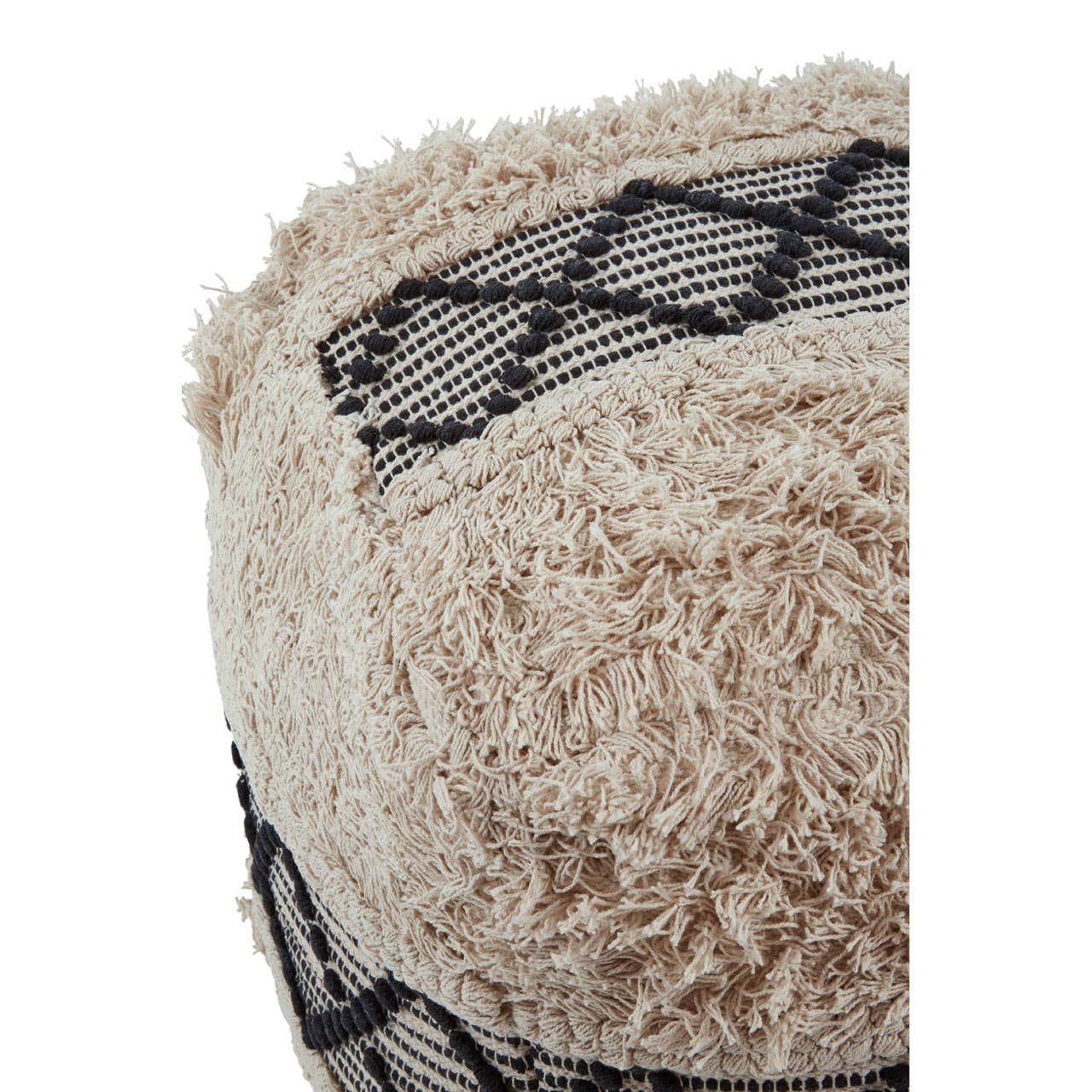 A close-up view of a black and white shaggy pouffe featuring a textured, fluffy surface with a geometric pattern. The pouffe has a rounded shape, showcasing a mix of soft white fibers and black accents