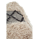 A close-up view of a shaggy pouffe featuring a textured beige surface with black and white woven patterns. The pouffe has a soft, fluffy appearance, highlighting its cozy and inviting design