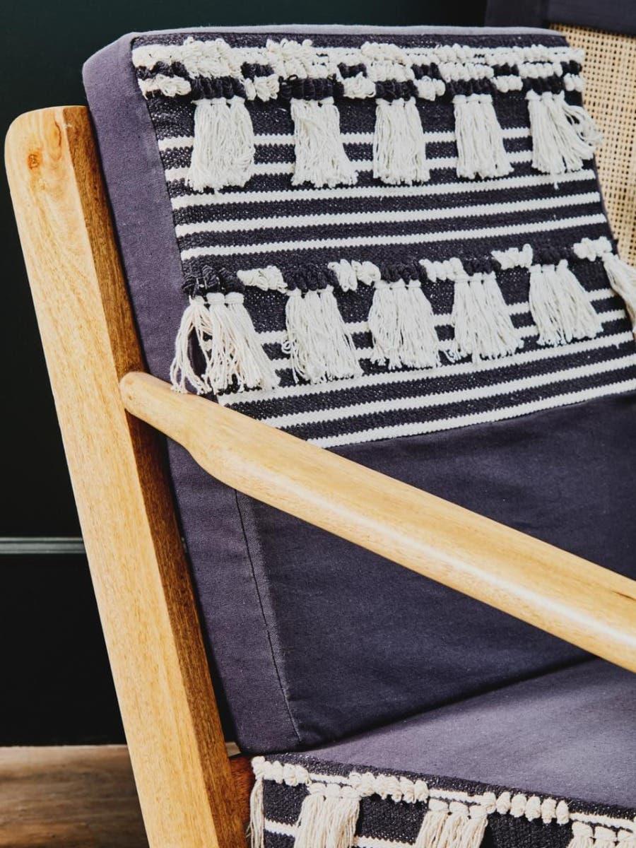 Striped fabric armchair with wooden frame and textured cream tassel detailing