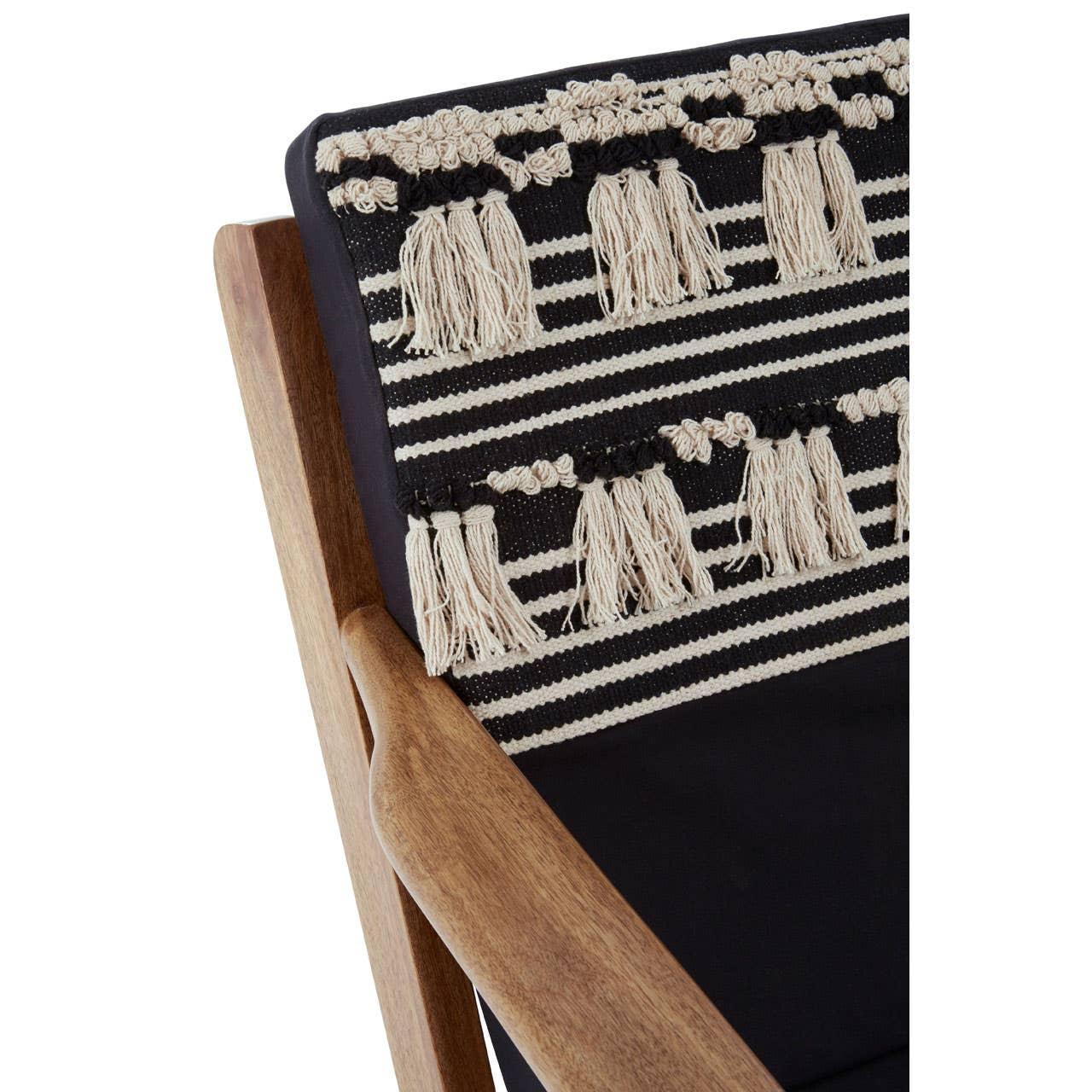 Wooden chair with black and cream striped cushion featuring tassel fringe detail