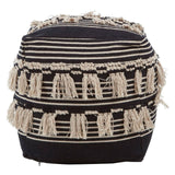 Round pouffe featuring a black and white shaggy design with textured fringes. The pouffe has a cylindrical shape and is adorned with horizontal stripes of varying thickness in black and cream colors