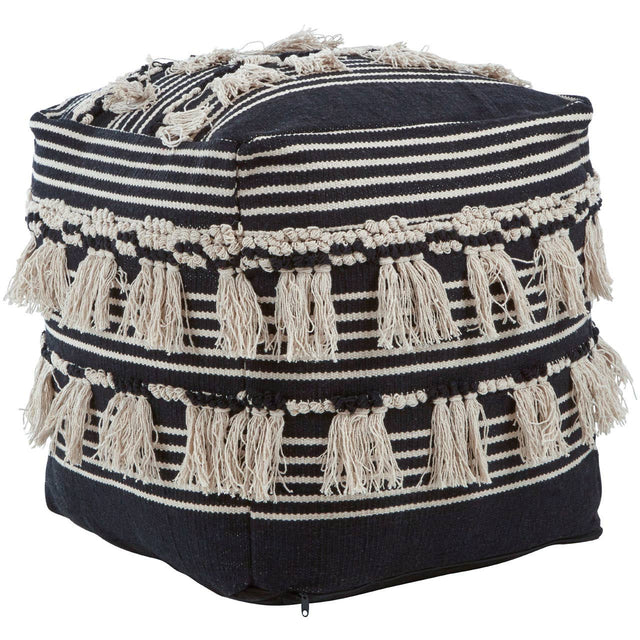 A black and white shaggy pouffe featuring a geometric pattern with alternating stripes and tassels along the edges, providing a textured and stylish accent for home decor