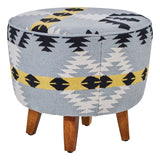 Round footstool featuring a colorful Kilim-style fabric with geometric patterns in blue, black, and yellow, supported by four sturdy mango wood legs