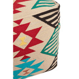 A multi-coloured pouffe featuring a kilim style design with geometric patterns in red, turquoise, black, and yellow on a beige background, showcasing a textured fabric surface and a cylindrical shape