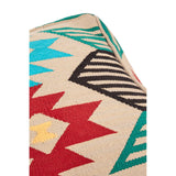 A multi-coloured pouffe featuring a kilim style design with geometric patterns in shades of turquoise, red, black, and green on a natural beige background, showcasing a textured fabric and a rounded shape