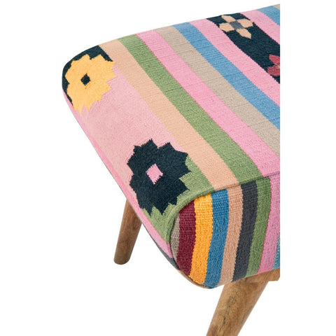 Multicoloured footstool featuring a vibrant striped fabric with floral patterns in shades of pink, green, yellow, and black, supported by wooden legs