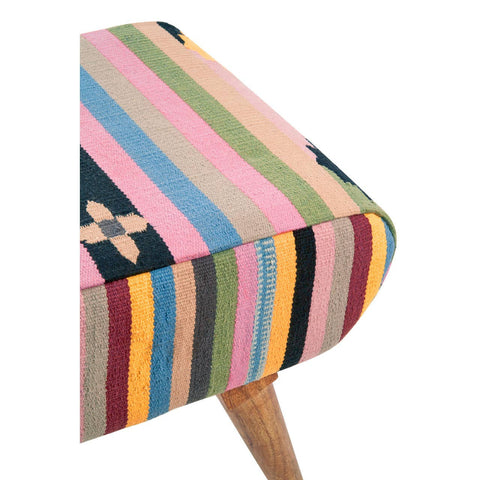 A corner view of a multicolour footstool featuring a striped fabric design in various shades, including pink, green, blue, and yellow, with a wooden leg supporting the base