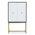 A two-door cabinet featuring a sleek black frame and white doors, complemented by gold handles and a minimalist design. The cabinet stands on slender gold legs, creating a modern and stylish look suitable for home decor