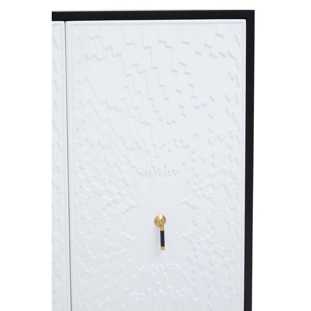 A close-up view of the Dumas Black and White Two Door Cabinet featuring a textured white door with a black frame and a gold handle. The cabinet has a modern design, emphasizing its sleek lines and contrasting colors